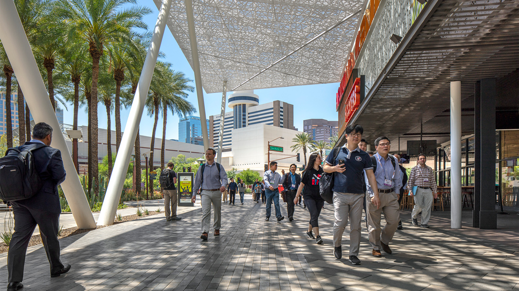 A group of people walking on a street.