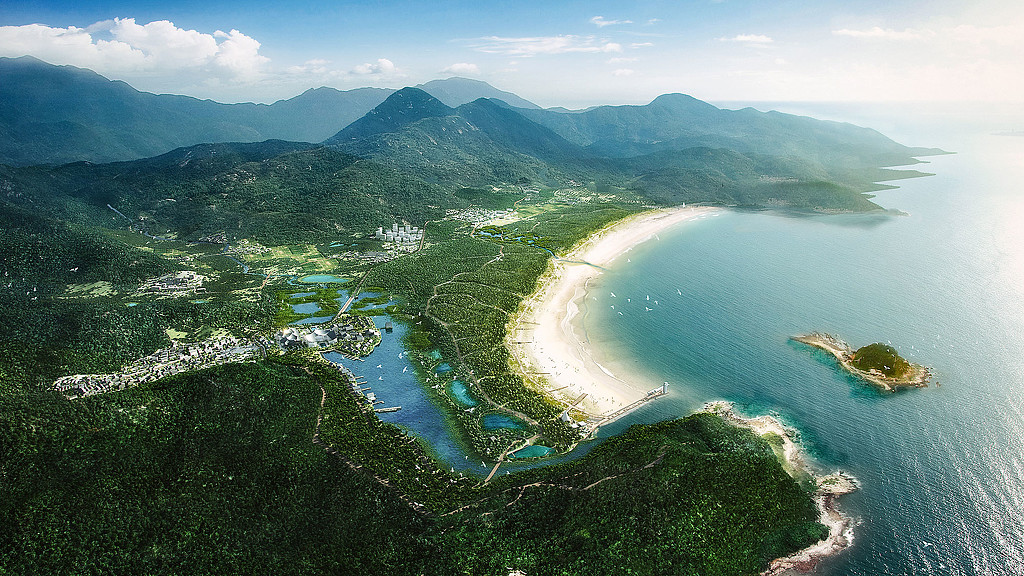 A beach with islands and mountains in the background.